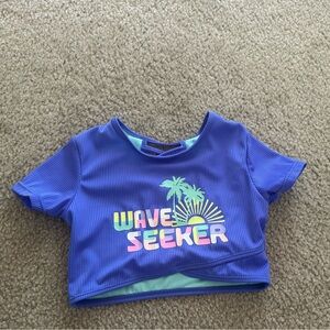 Girl swimming Blue Wave Seeker Crop Top size 7-8